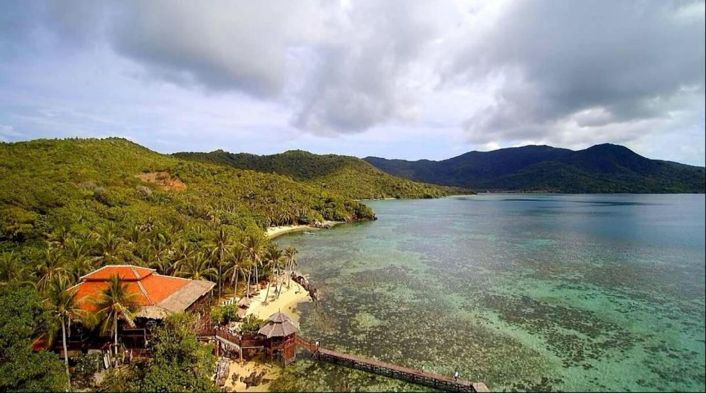 an aerial view of a beach and the ocean at Breve Azurine Lagoon Resort in Karimunjawa