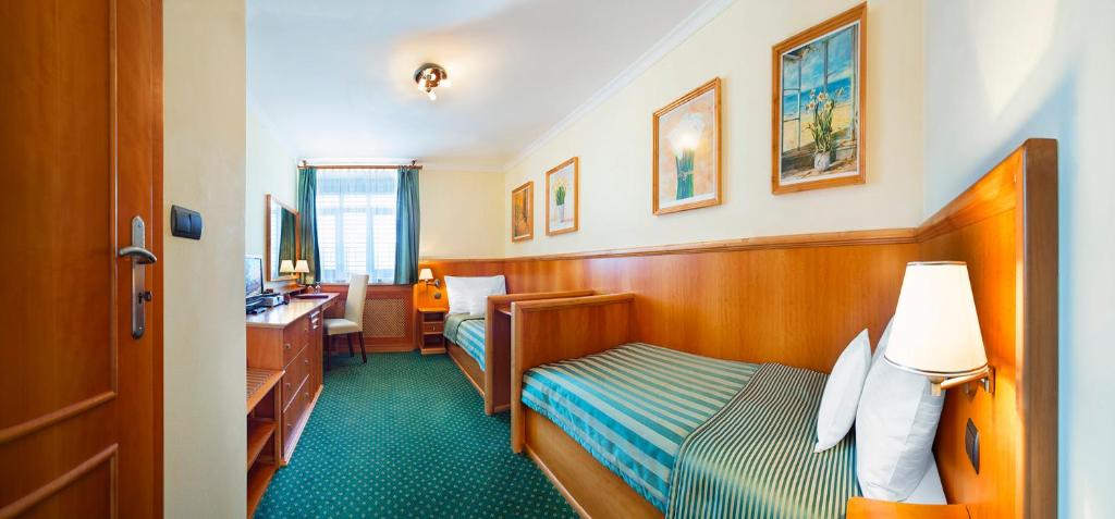 Postel nebo postele na pokoji v ubytování Hotel Abácie & Wellness