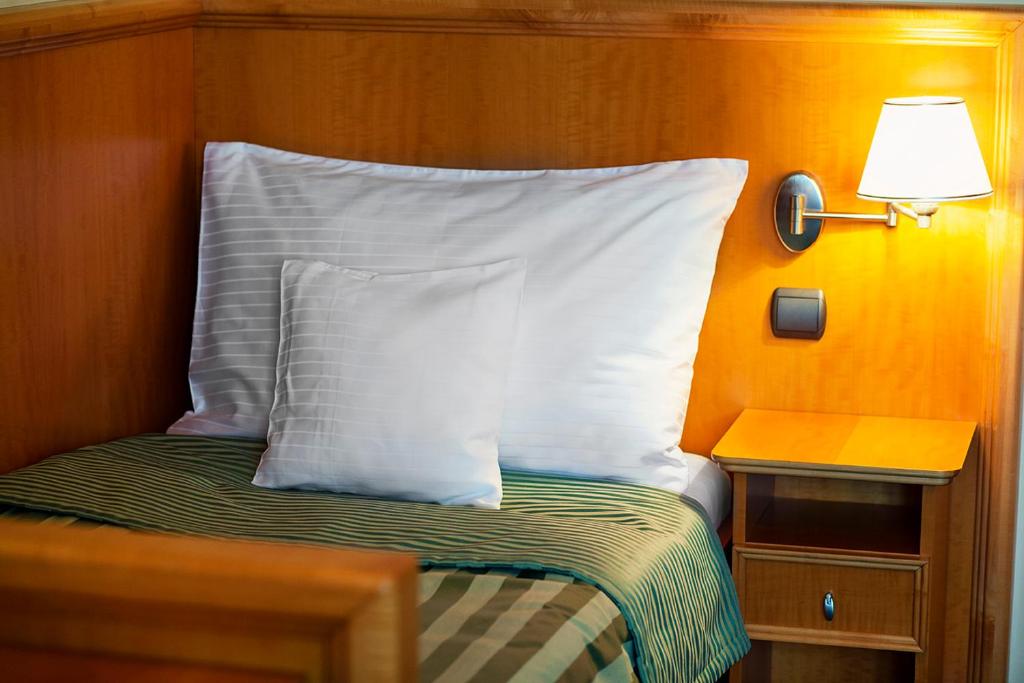 Postel nebo postele na pokoji v ubytování Hotel Abácie & Wellness