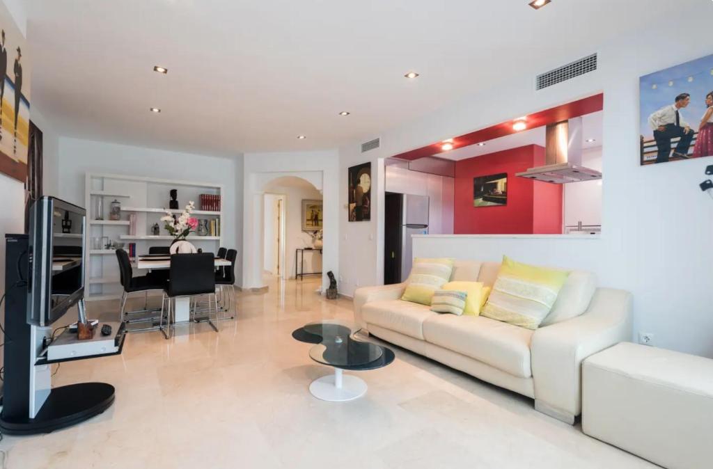 a living room with a white couch and a table at Charming 2 Bedroom Trocadero Arena area in Marbella