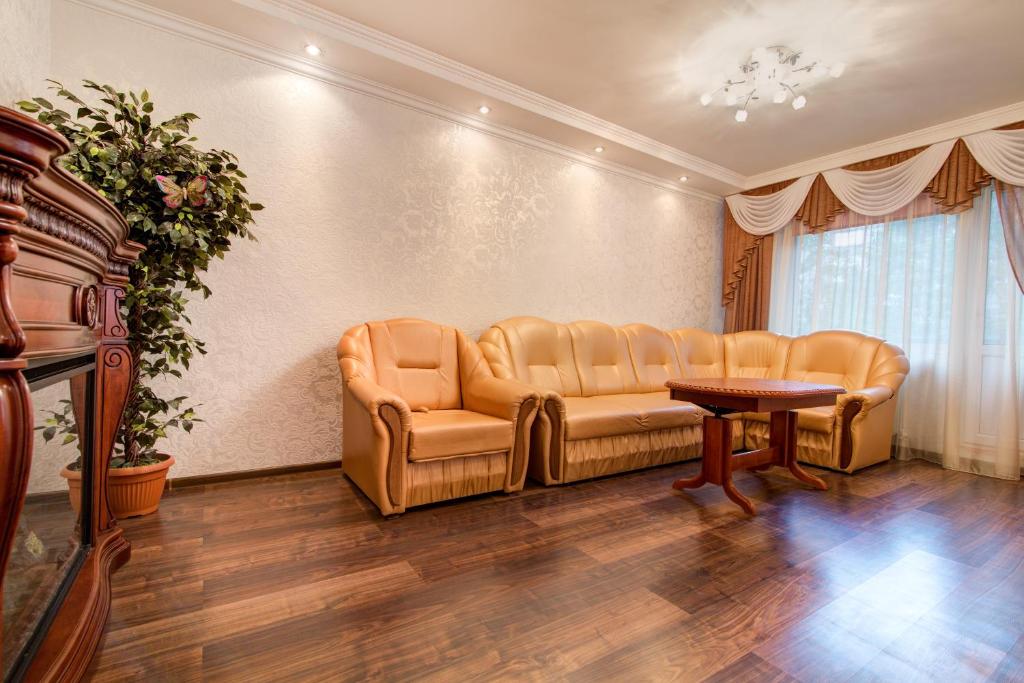 a living room with a couch and a table at Apartments in a developed area in Dnipro