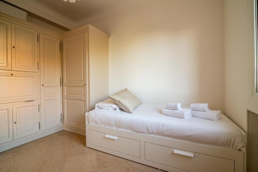 a bedroom with a bed with two towels on it at Villa Primavera Splendid villa with sea view in Saint-Jean Cap Ferrat in Saint-Jean-Cap-Ferrat