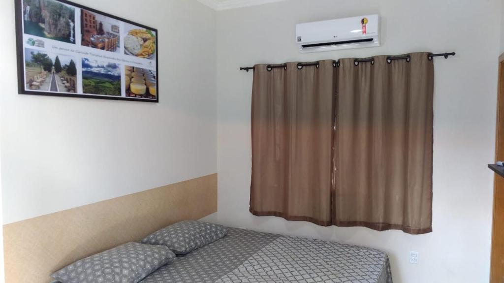 Säng eller sängar i ett rum på Recanto das Gerais