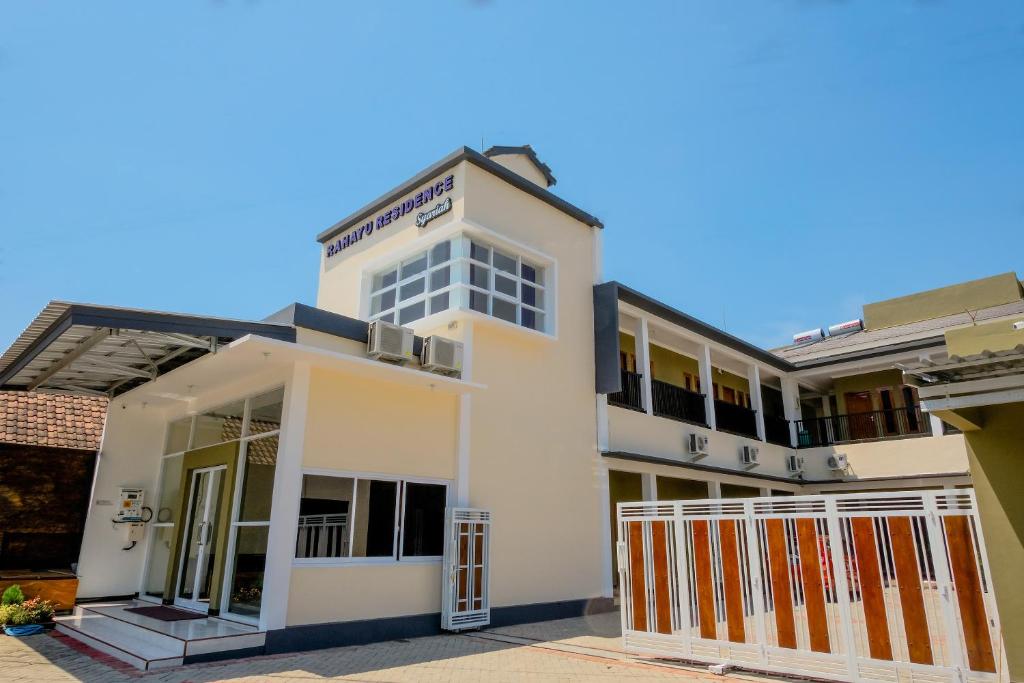 a white building with a gate in front of it at Rahayu Residence Syariah Kediri in Kediri