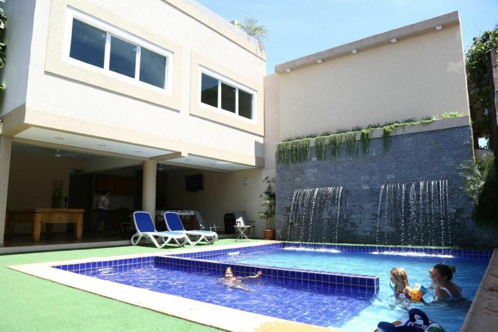 a swimming pool in front of a house at Arthur Palace Hotel in Encarnación