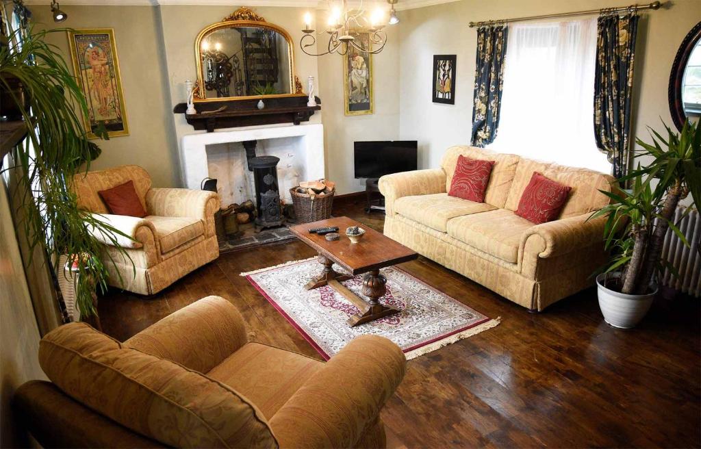 a living room with two couches and a fireplace at Quaraing House in Staffin