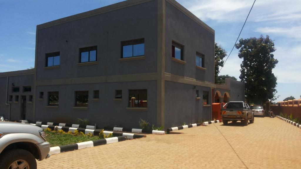 a building with a truck parked in front of it at Hotel Skypa in Yumbe