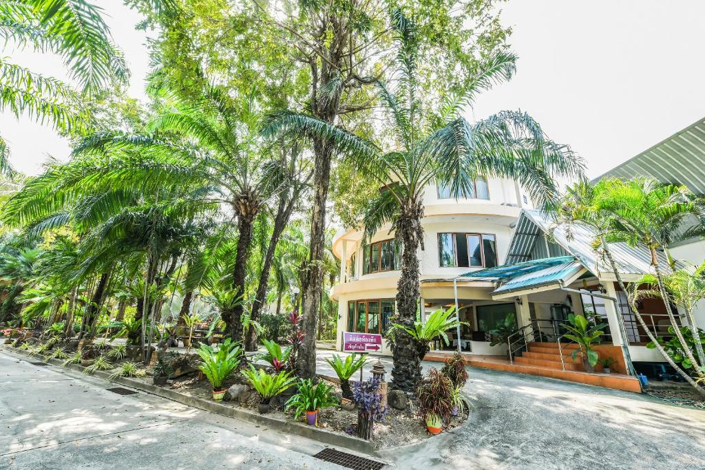 a house with palm trees in front of it at Suan Palm Garden View in Rayong