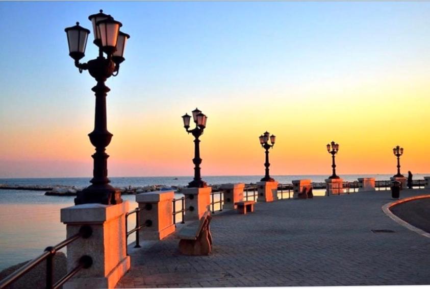 a row of street lights and benches on the beach at Palazzo Grigio in Bari