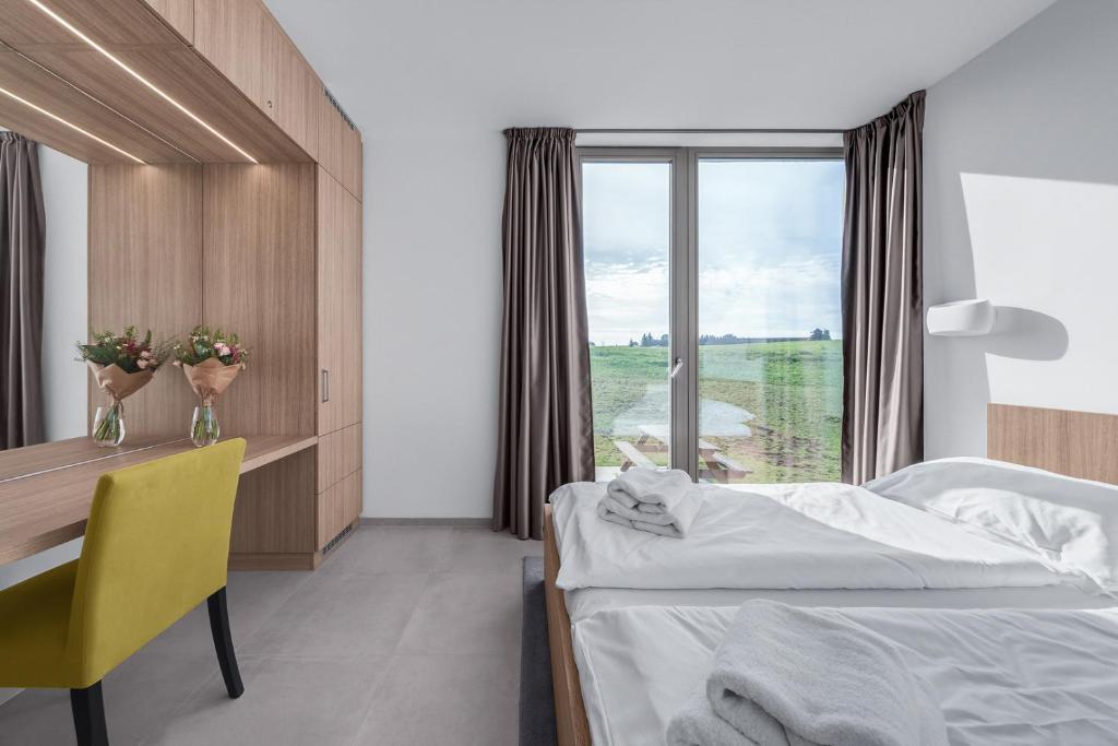 Postel nebo postele na pokoji v ubytování Apartmány HRÁDEČEK