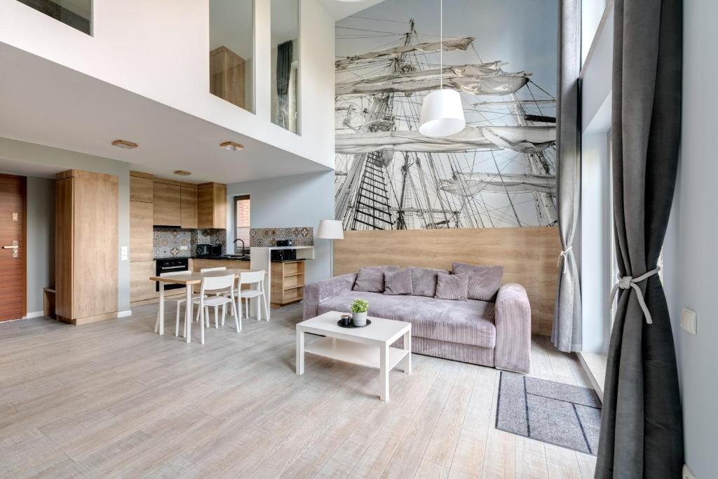 a living room with a couch and a table at 3 City Apartments - Waterlane Valhalla in Gdańsk