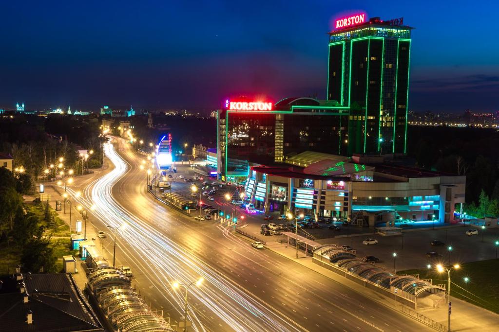 a city lit up at night with traffic on a highway at Hotel Korston Royal Kazan in Kazan