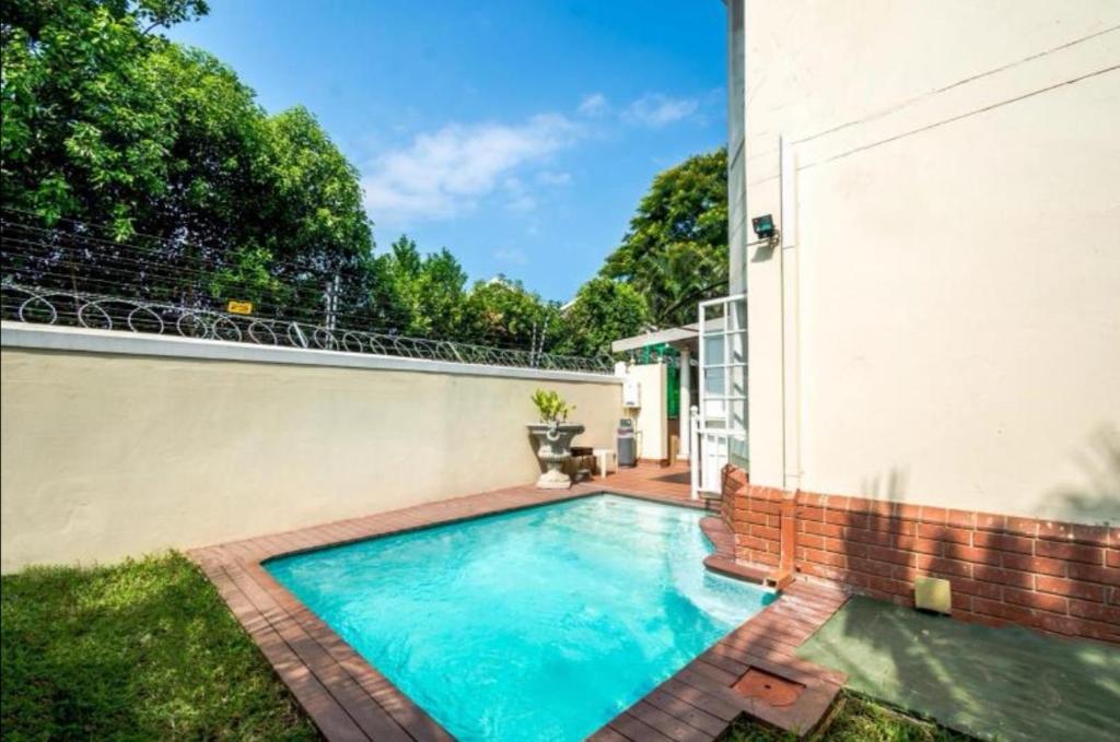 a swimming pool in the backyard of a house at Mount Edgecombe Guest House in Mount Edgecombe