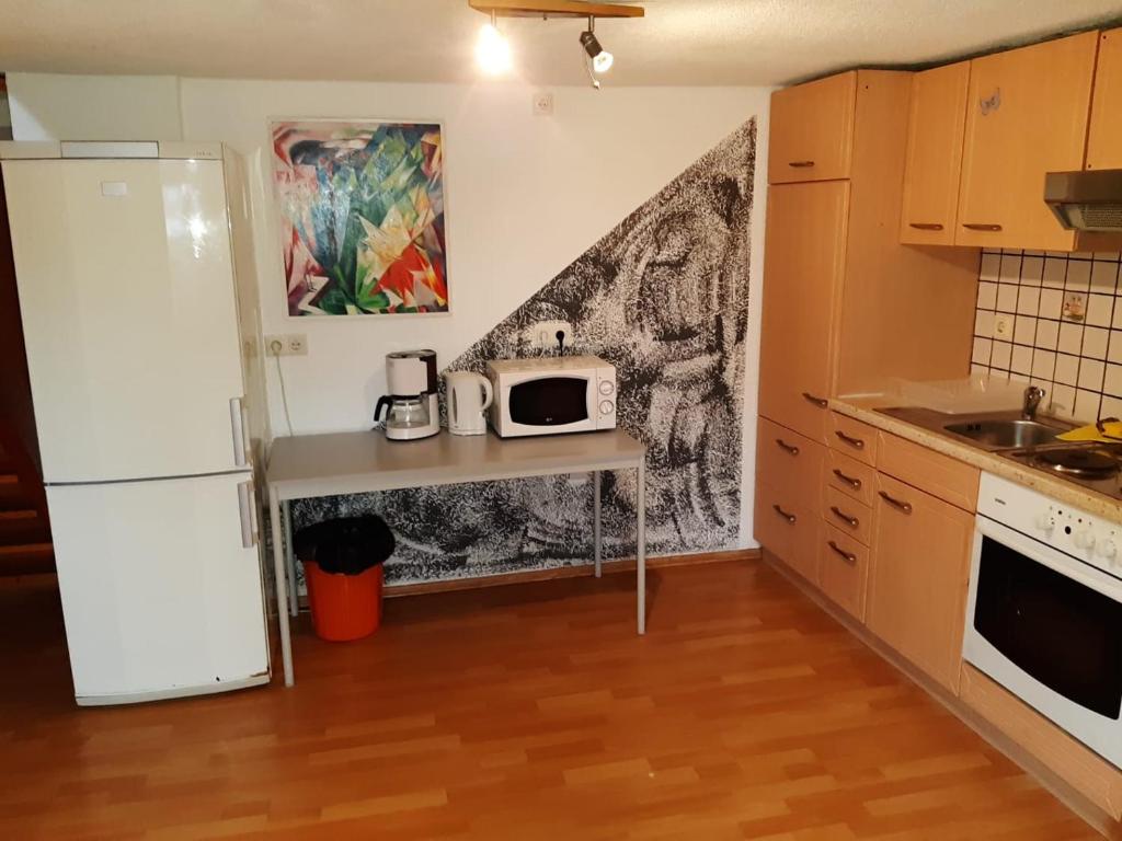 a kitchen with a table with a microwave on it at Apartment Öffingen 77 in Fellbach