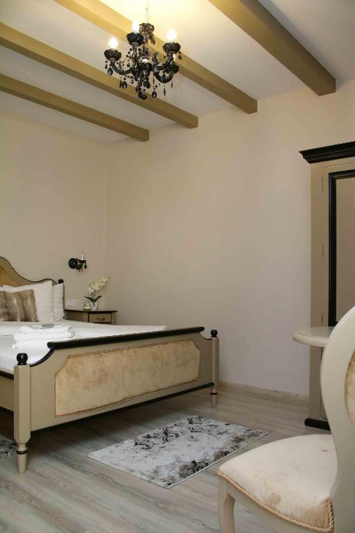 a bedroom with a bed and a chandelier at Pensiunea Casa Helis in Sibiu
