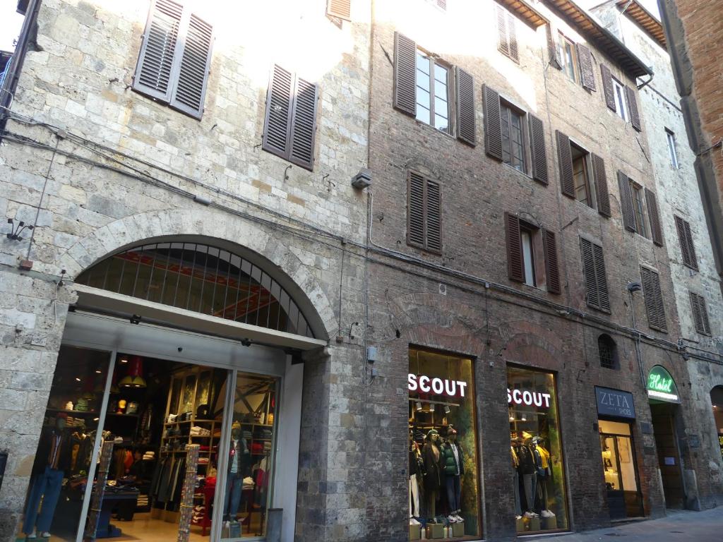 a brick building with a store front with windows at Albergo Cannon d'Oro in Siena