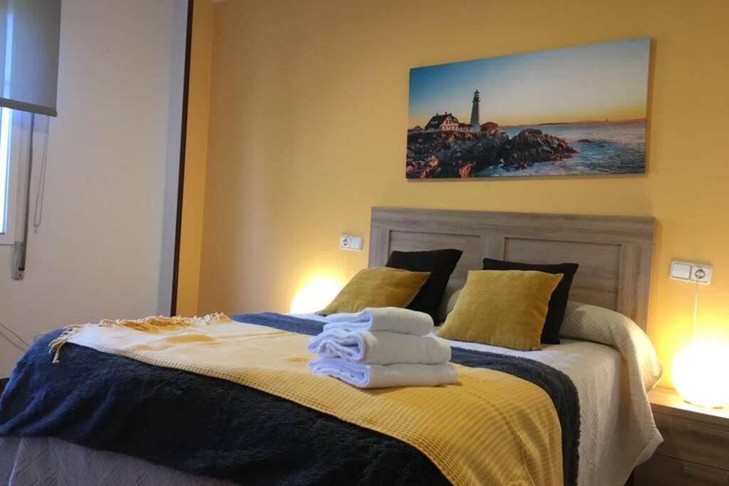 a bedroom with a bed with towels on it at PISO A 400 METROS DE LA CATEDRAL in Santiago de Compostela