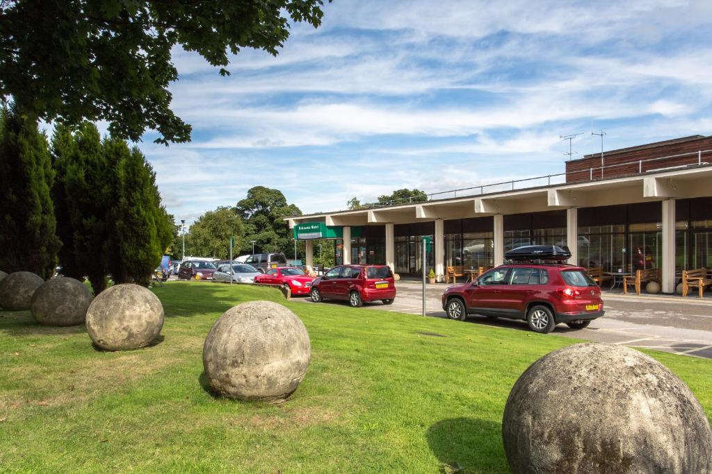 a group of spheres sitting on the grass in front of a building at Britannia Leeds Bradford Airport in Bramhope