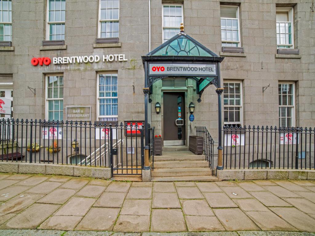 a building with a gate in front of a hotel at OYO Flagship Brentwood in Aberdeen