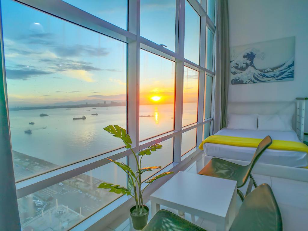 a room with a window with a view of the ocean at Maritime Suites by Comfy in George Town