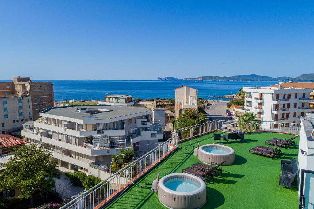 a city with lots of green grass and buildings at Hotel Villa Piras in Alghero