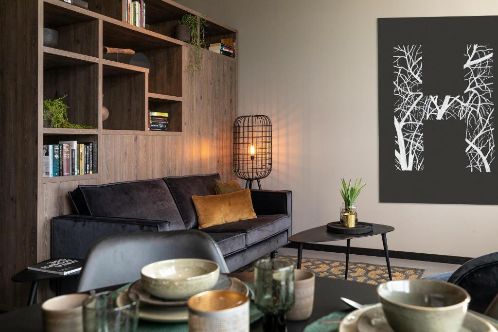 a living room with a couch and a table at Hilversum City Apartments in Hilversum