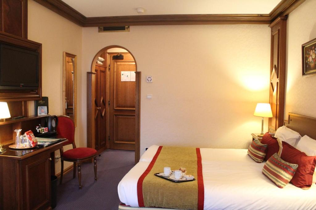 Postel nebo postele na pokoji v ubytování Hotel Le Mandelberg