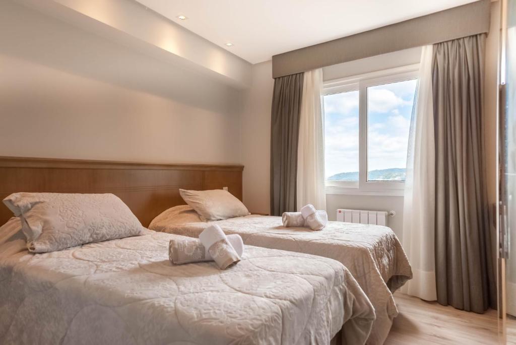 En eller flere senge i et værelse på Via Florida Luxo I - 302