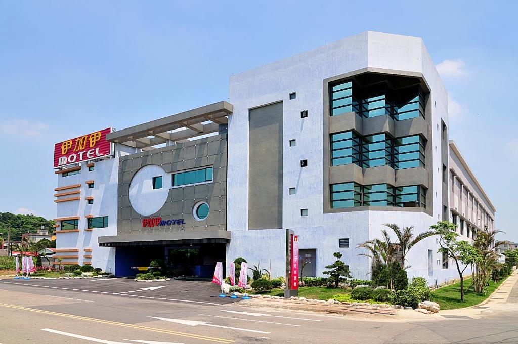 a building with a hotel on the side of a street at One + One Motel in Longtan