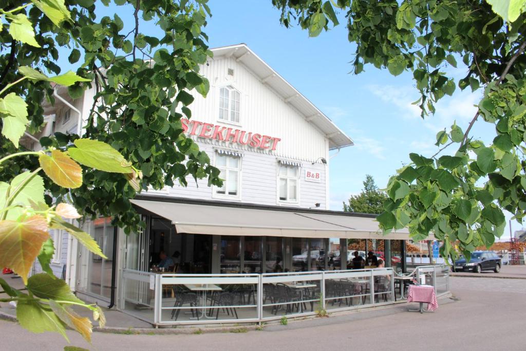 a white building with a sign that reads restaurant at Stekhuset B&B in Kalmar