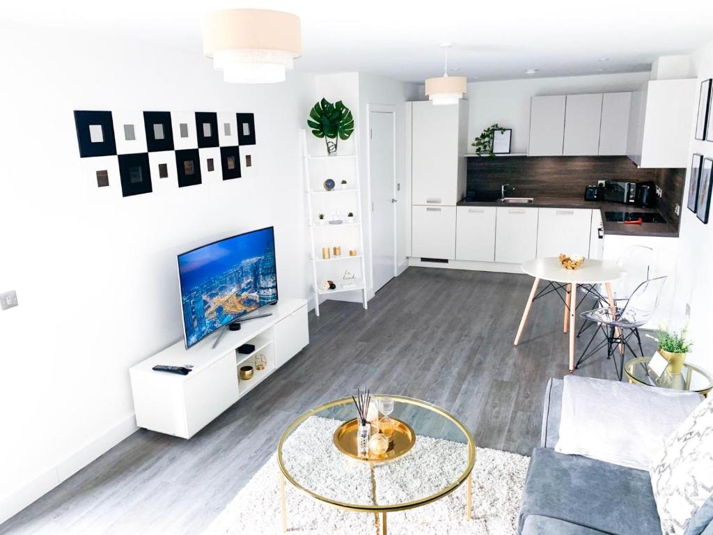 a living room with a couch and a table at Luxury Birmingham City Centre Apartment in Birmingham