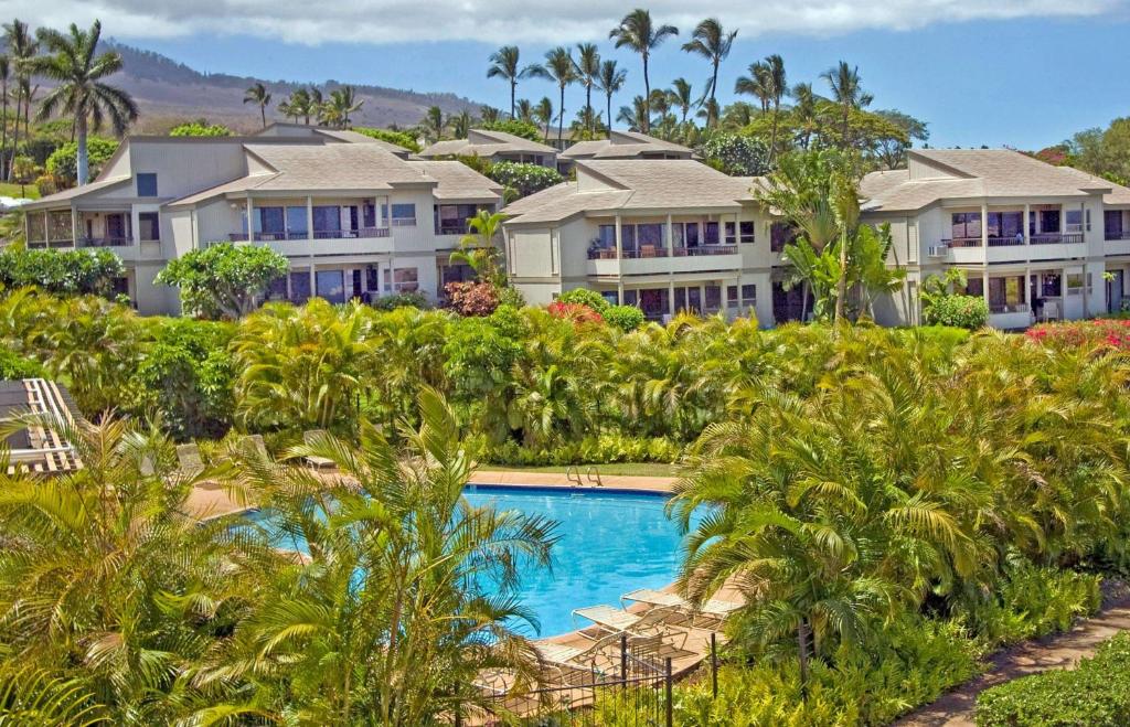 a row of houses on a hill with a swimming pool at Wailea Ekolu Village - CoralTree Residence Collection in Wailea