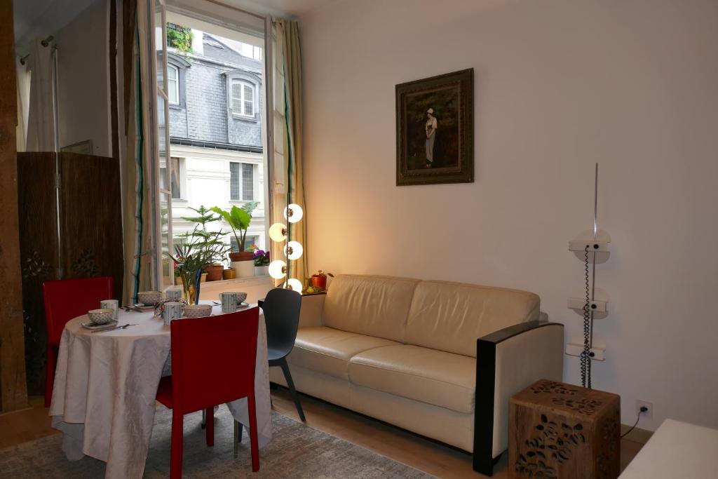 a living room with a couch and a table at Appartment near Louvre, central in Paris