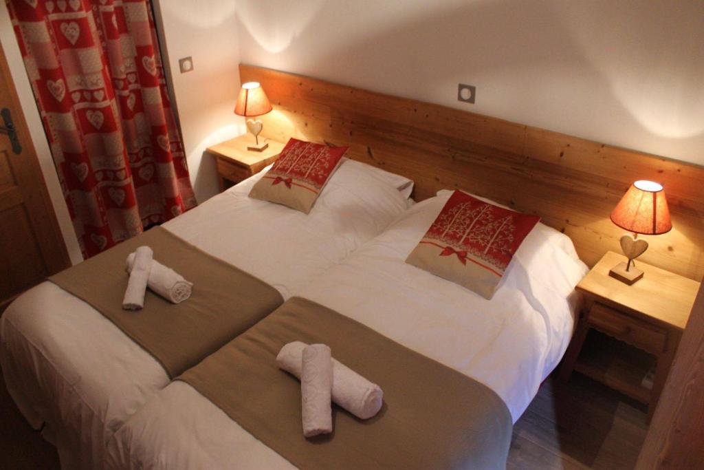 - une chambre d'hôtel avec 2 lits et des serviettes dans l'établissement Chalet Petite Etoile Des Neiges, à L'Alpe-d'Huez