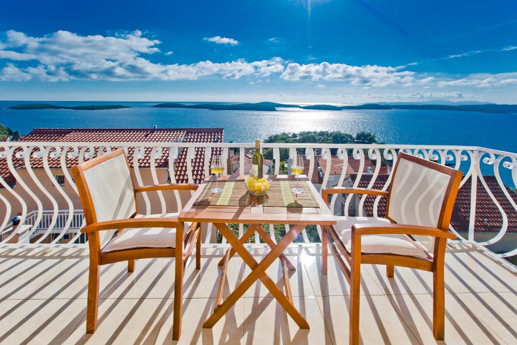 a table on a balcony with a view of the ocean at Apartments Tatjana Dominis in Hvar