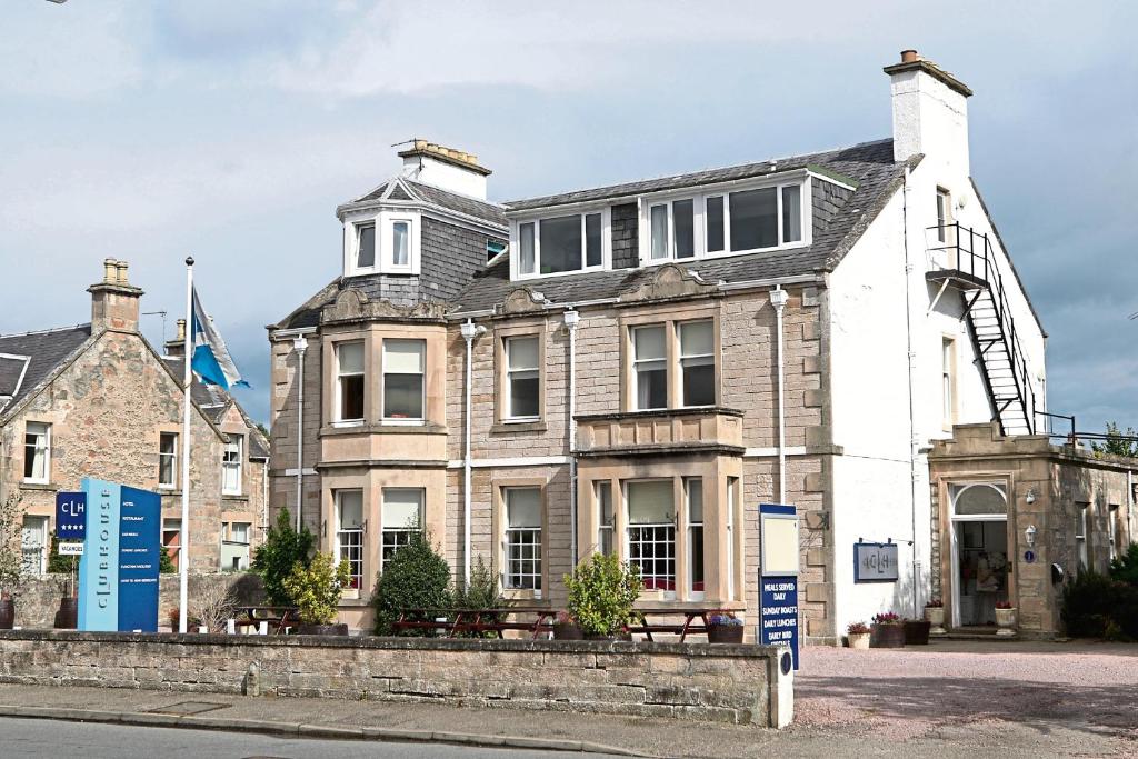 a large house with a tower on top of it at Club House Hotel & Restaurant in Nairn