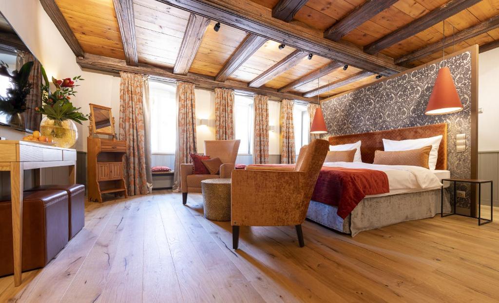 Schlafzimmer mit einem Kingsize-Bett und einem Schreibtisch in der Unterkunft Romantik Hotel Markusturm in Rothenburg ob der Tauber