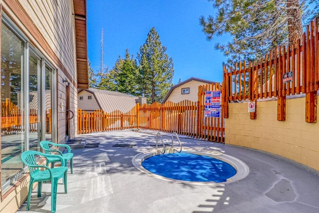 a patio with two chairs and a small pool at Mammoth View Villas 35 in Mammoth Lakes