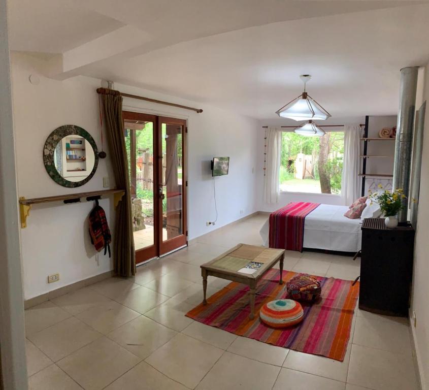 a bedroom with a bed and a table in a room at La casa de Caro in Mar de Cobo