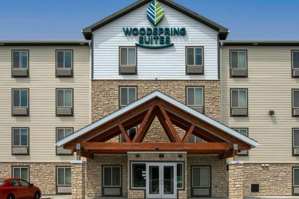 a building with a sign on top of it at Woodspring Suites Cherry Hill in Cherry Hill