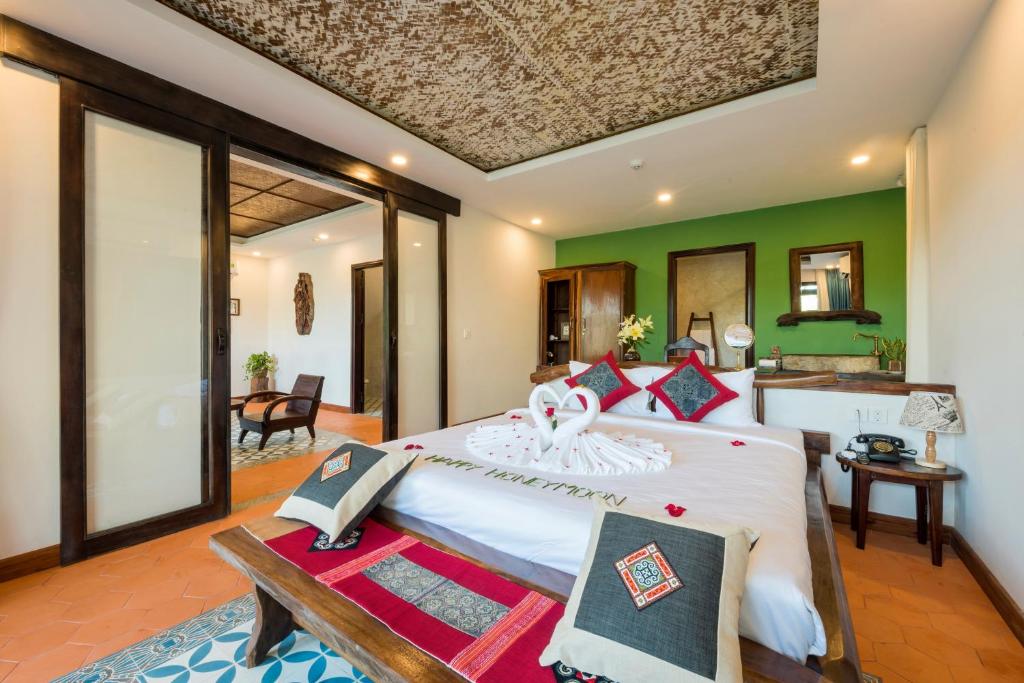 Postel nebo postele na pokoji v ubytování Zest Resort & Spa Hoi An