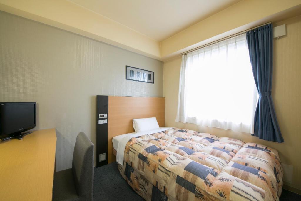 Postel nebo postele na pokoji v ubytování Hotel Econo Taki