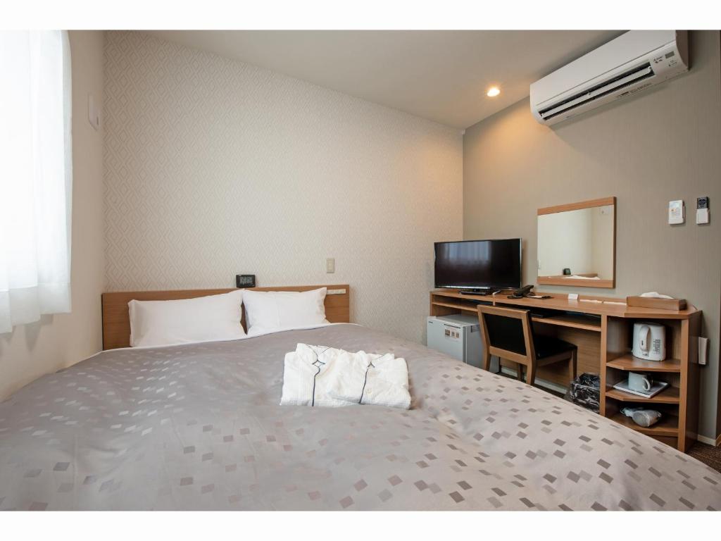 Postel nebo postele na pokoji v ubytování Amagasaki Plaza Hotel Hanshin Amagasaki