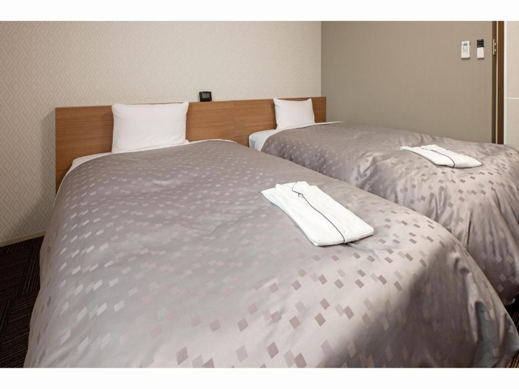 Postel nebo postele na pokoji v ubytování Amagasaki Plaza Hotel Hanshin Amagasaki