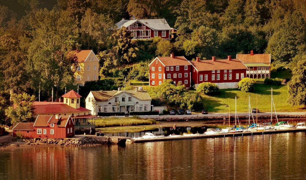 a small town next to a body of water with boats at Gustafsbergs Badhotell & Vandrarhem in Uddevalla