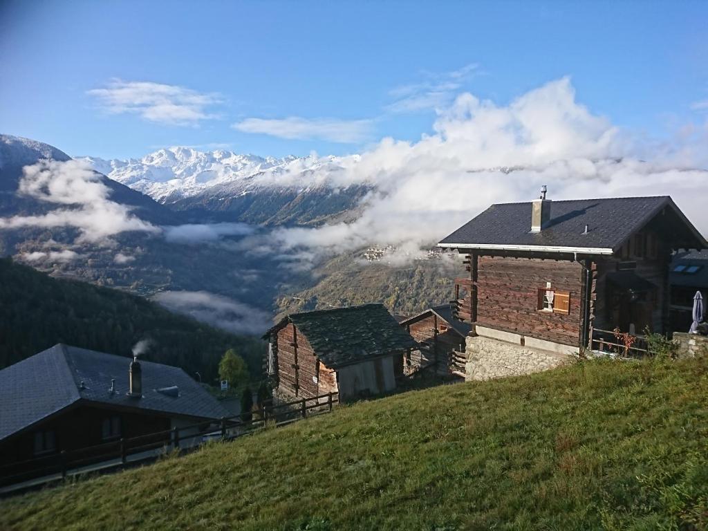 a house on a hill with a view of mountains at Chalet "Chez Claudine et Charles" in Mase