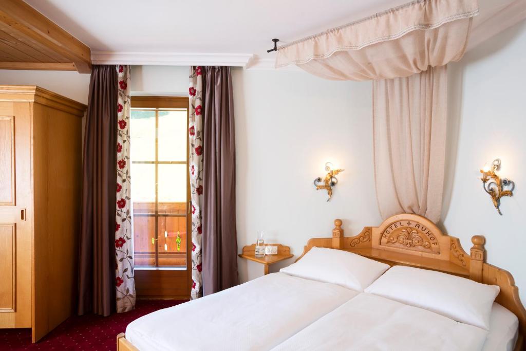 A bed or beds in a room at Hotel Auhof