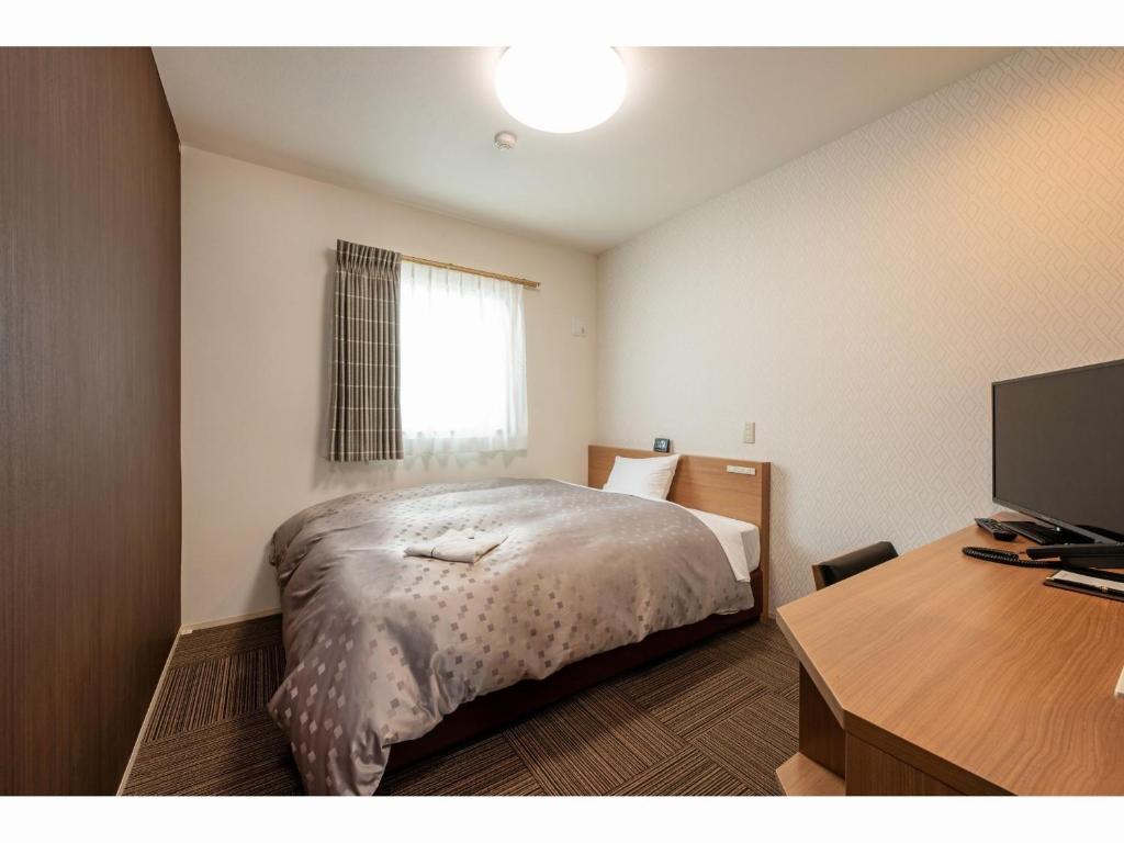 Postel nebo postele na pokoji v ubytování Amagasaki Plaza Hotel Hanshin Amagasaki