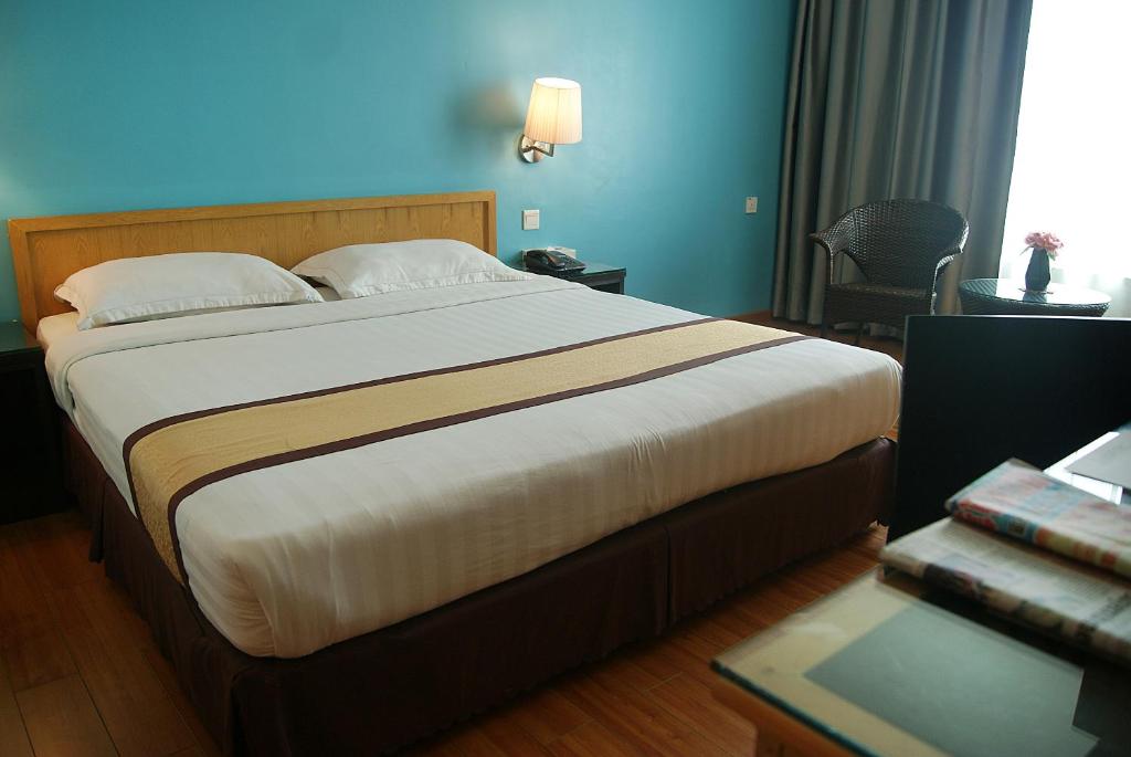 Postel nebo postele na pokoji v ubytování Tang Dynasty Bay Hotel