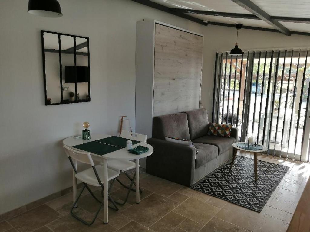 a living room with a couch and a table at Gite aux Lauriers d'Adhémar in La Garde-Adhémar